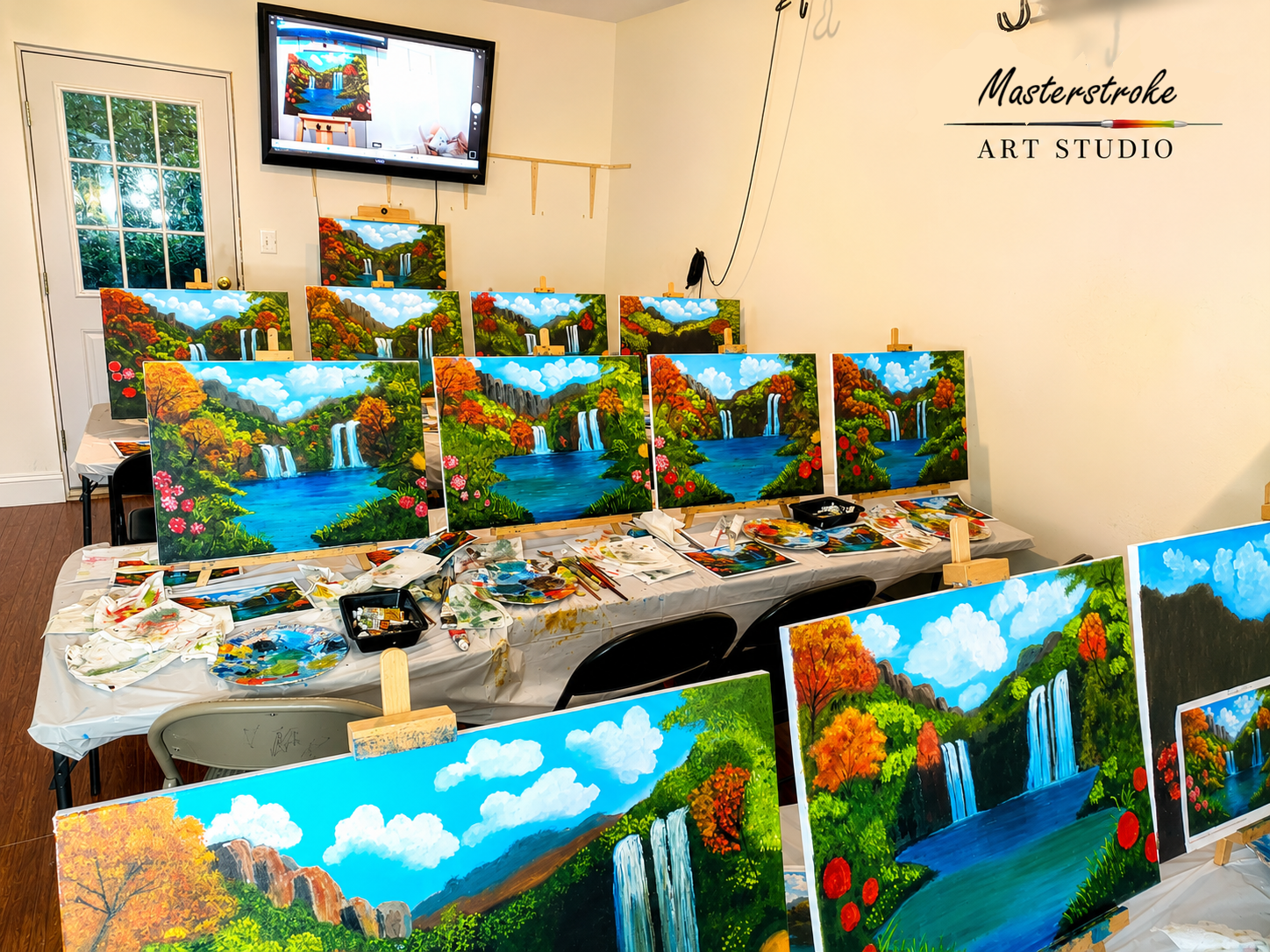 Inside the Masterstroke art studio — easels with waterfall paintings